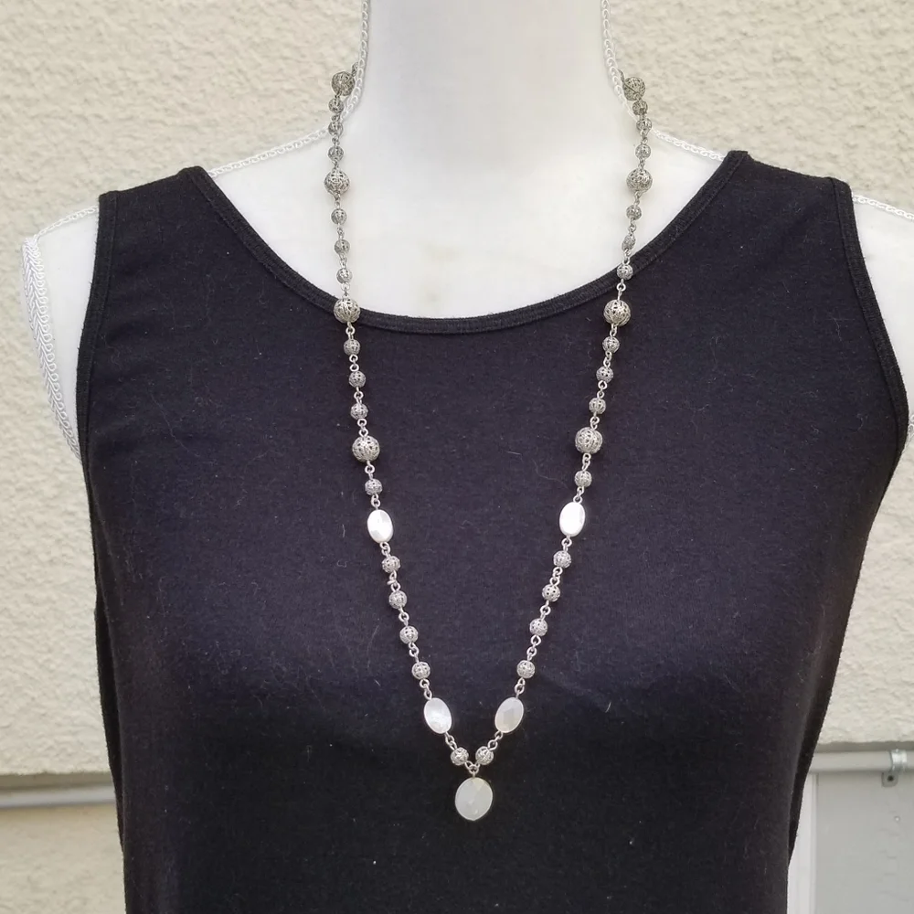 silver tone filigree ball necklace with white iridescent flat beads